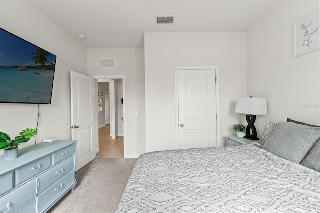 bedroom with light colored carpet, visible vents, and baseboards