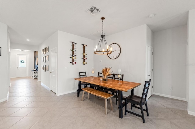 dining space with baseboards, light tile patterned flooring, visible vents, and an inviting chandelier