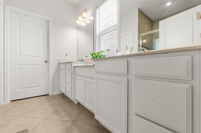 full bathroom featuring a stall shower, vanity, and tile patterned floors