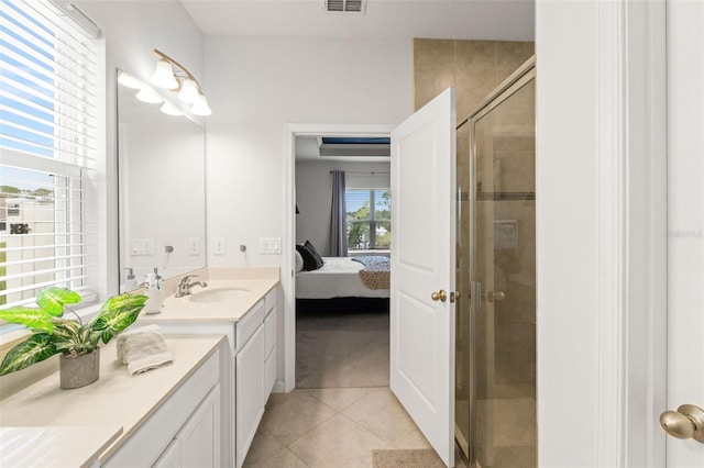 ensuite bathroom featuring a stall shower, visible vents, connected bathroom, tile patterned flooring, and vanity