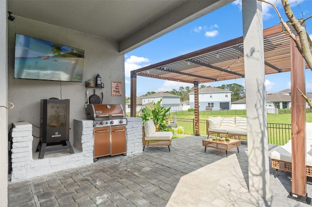 view of patio featuring an outdoor kitchen, a grill, fence, an outdoor living space, and a pergola