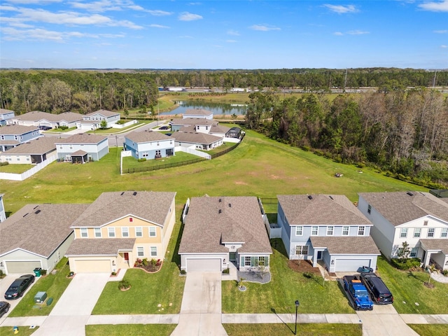 aerial view with a residential view, a water view, and a view of trees