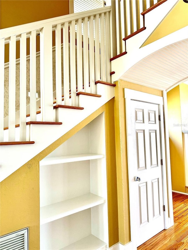 stairs featuring wood finished floors