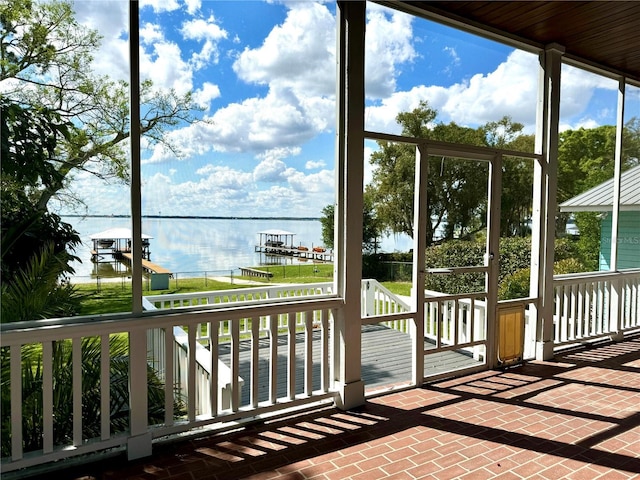 unfurnished sunroom with a water view