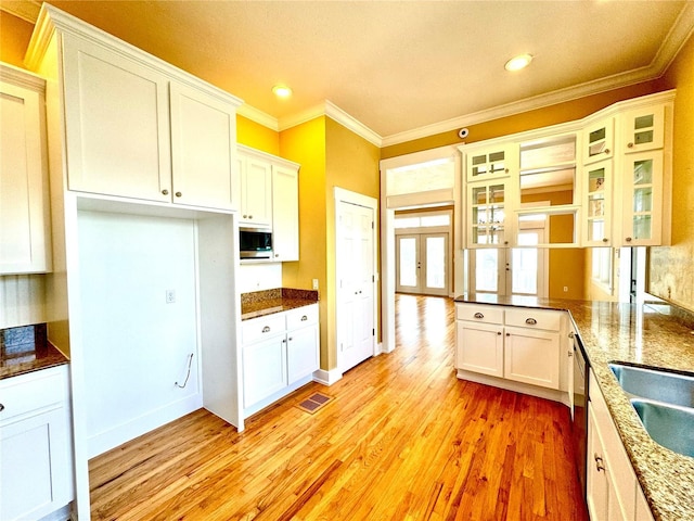 kitchen featuring french doors, crown molding, visible vents, light wood-style floors, and white cabinets