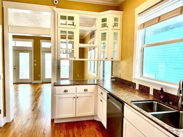 kitchen with a sink, white cabinets, dark wood-style flooring, and stainless steel dishwasher