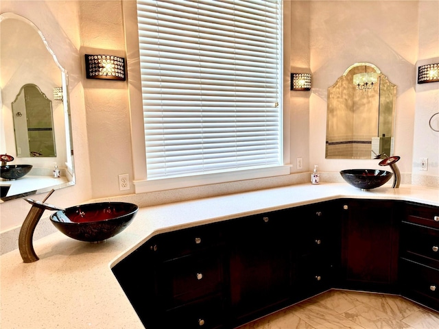 bathroom with marble finish floor and vanity