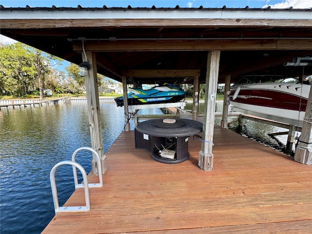 dock area with a water view and boat lift