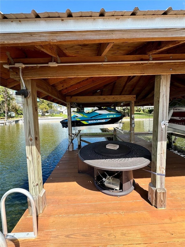 dock area with a water view and boat lift