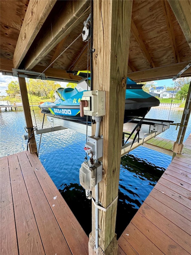 dock area with a water view and boat lift