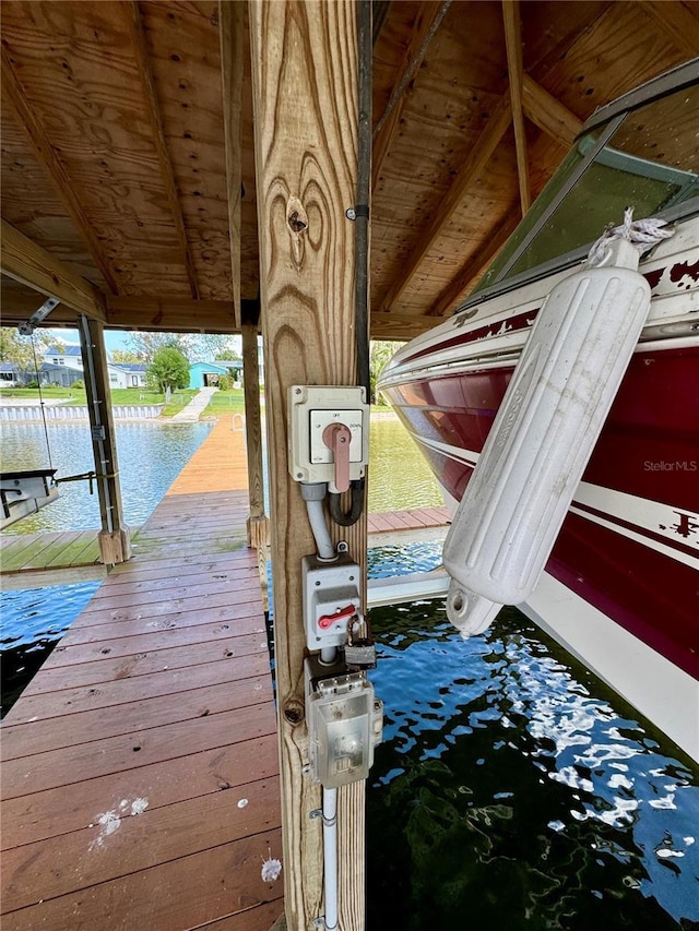 dock area with a water view and boat lift