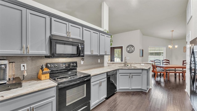 kitchen featuring black appliances, tasteful backsplash, gray cabinets, and a sink