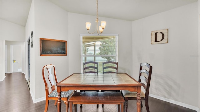 dining room with lofted ceiling, baseboards, a chandelier, and dark wood-style flooring