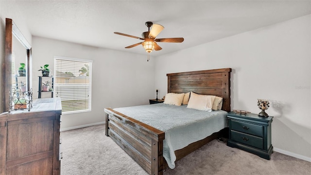 bedroom featuring a ceiling fan, light carpet, and baseboards