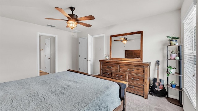 bedroom with visible vents, ceiling fan, and light carpet