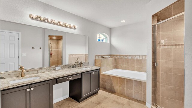 bathroom with a stall shower, a garden tub, and a sink