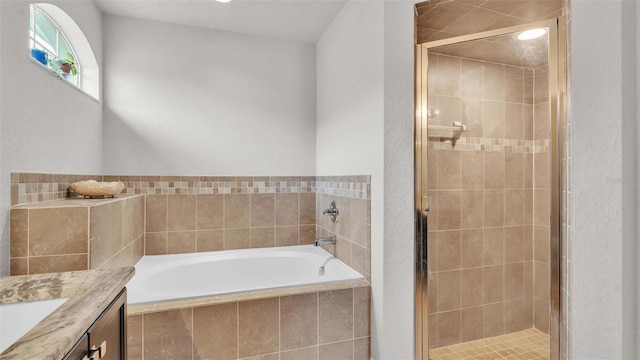 bathroom with vanity, a shower stall, and a bath