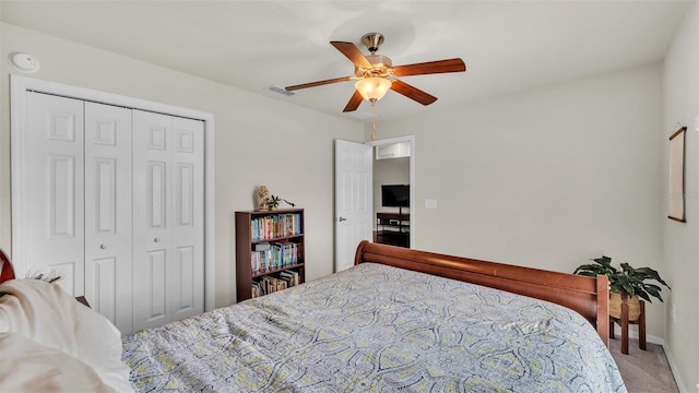 carpeted bedroom featuring a closet, visible vents, and a ceiling fan