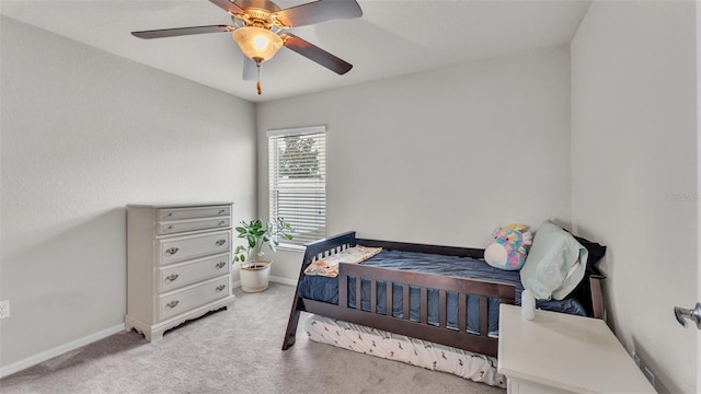 bedroom with ceiling fan, carpet flooring, and baseboards