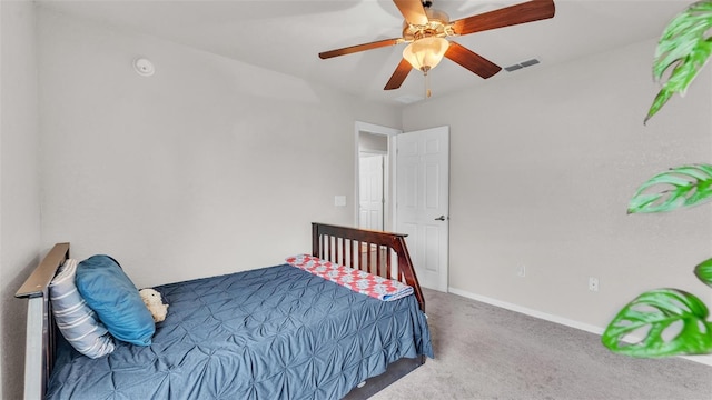 carpeted bedroom with a ceiling fan, visible vents, and baseboards