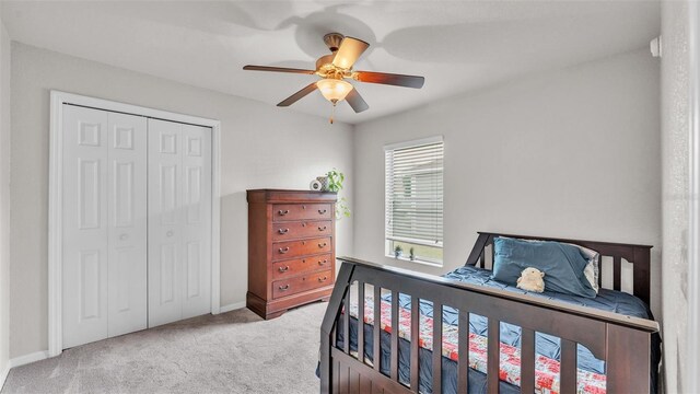 bedroom with carpet floors, a closet, ceiling fan, and baseboards