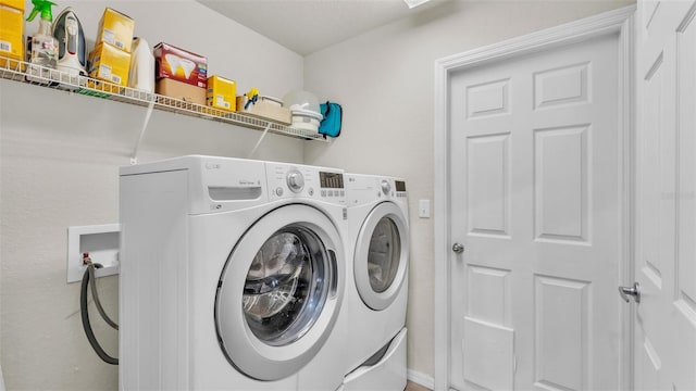 washroom featuring washing machine and dryer and laundry area