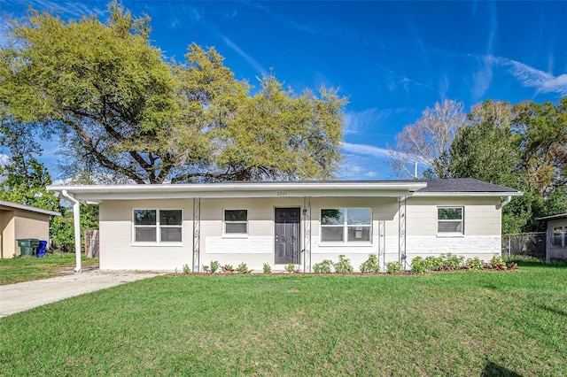 single story home with fence and a front lawn