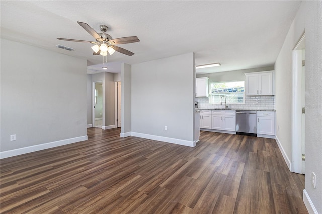 unfurnished living room featuring a ceiling fan, baseboards, visible vents, dark wood-style flooring, and a sink