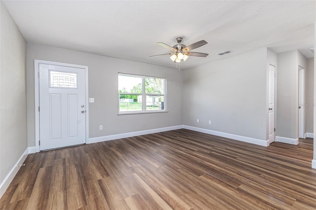 entrance foyer with visible vents, a ceiling fan, baseboards, and dark wood-style flooring