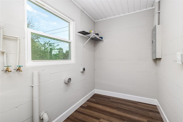 washroom featuring baseboards, laundry area, electric panel, electric dryer hookup, and dark wood-type flooring