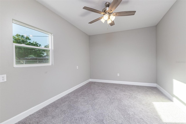 unfurnished room with a ceiling fan, baseboards, and carpet floors