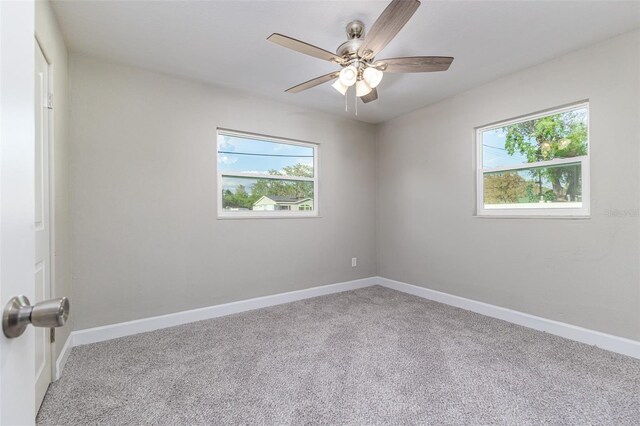 spare room with baseboards, carpet floors, and ceiling fan