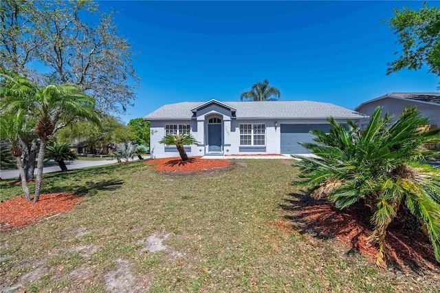 single story home with stucco siding, an attached garage, and a front lawn