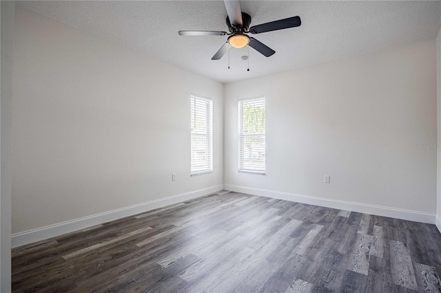 unfurnished room with a textured ceiling, dark wood-type flooring, baseboards, and ceiling fan