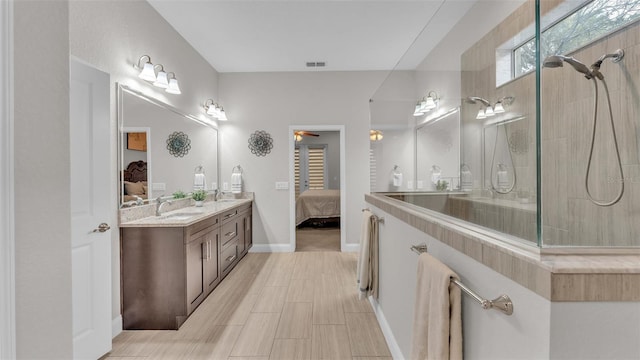 ensuite bathroom featuring visible vents, walk in shower, double vanity, ensuite bath, and a sink