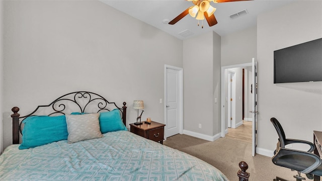 carpeted bedroom featuring visible vents, a ceiling fan, baseboards, and high vaulted ceiling