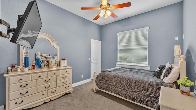 carpeted bedroom featuring a ceiling fan and baseboards