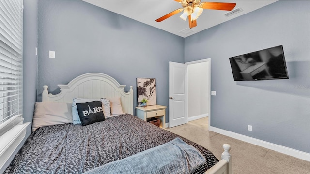 bedroom with visible vents, baseboards, light carpet, and a ceiling fan