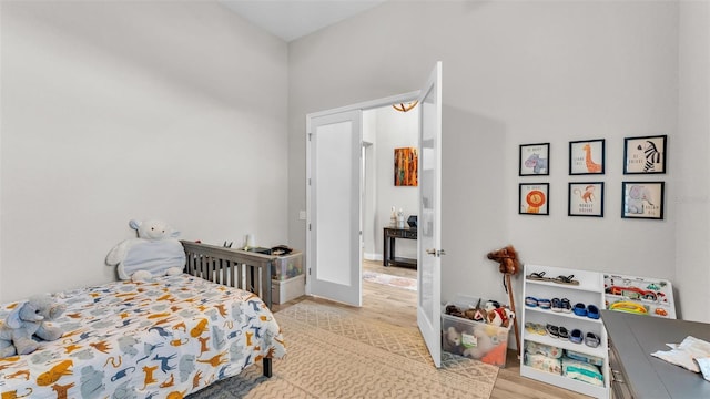 bedroom with light wood-style floors and baseboards