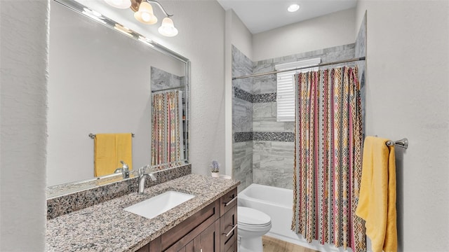 full bath with vanity, shower / tub combo, and toilet