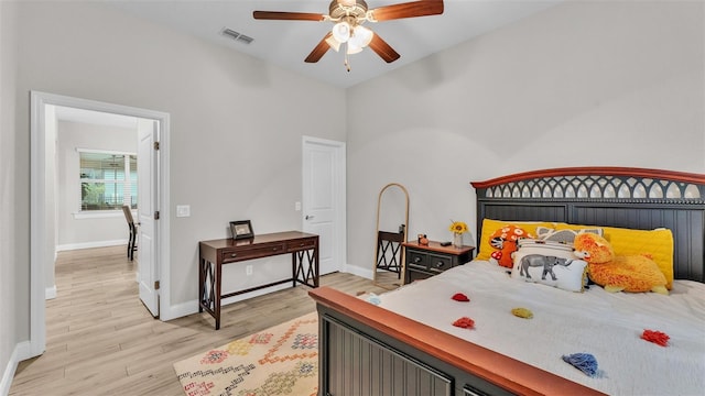 bedroom with visible vents, baseboards, ceiling fan, and light wood finished floors