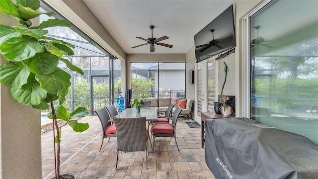 sunroom / solarium featuring ceiling fan