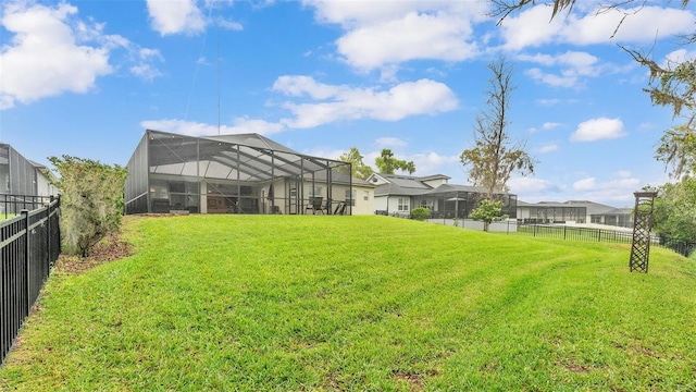 view of yard featuring glass enclosure and a fenced backyard