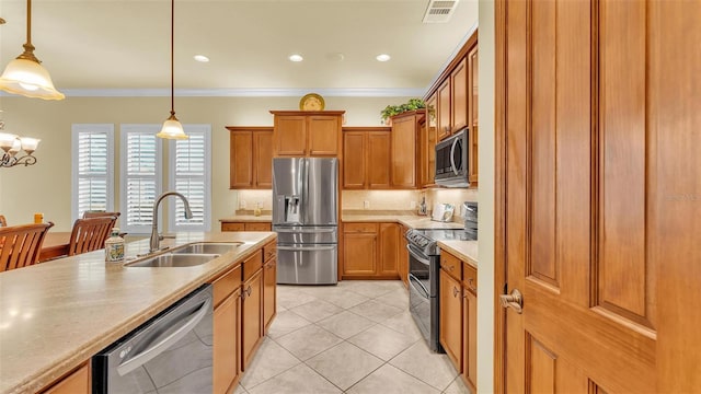 kitchen with stainless steel appliances, light countertops, visible vents, ornamental molding, and a sink