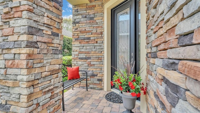 entrance to property with stone siding