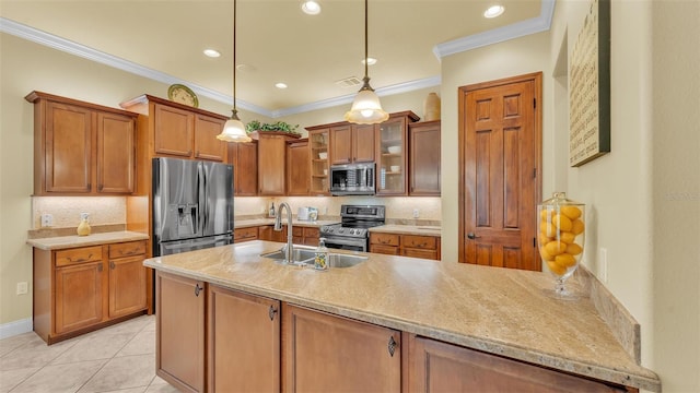 kitchen featuring brown cabinetry, tasteful backsplash, stainless steel appliances, and a sink