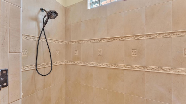 bathroom with a tile shower