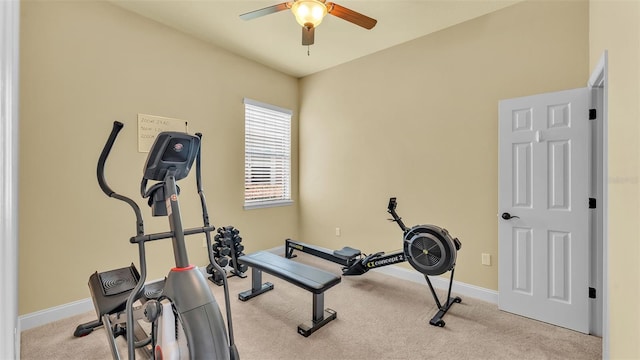 exercise area featuring carpet floors, baseboards, and a ceiling fan