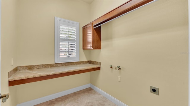 washroom with cabinet space, baseboards, and hookup for an electric dryer