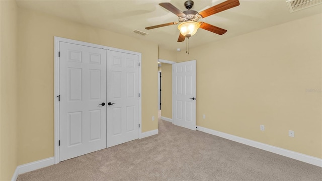 unfurnished bedroom featuring a closet, visible vents, baseboards, and carpet flooring